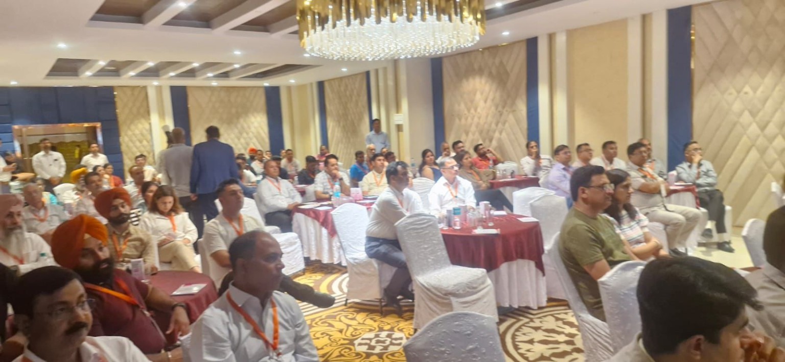 Audience seated at round tables during an educational gathering